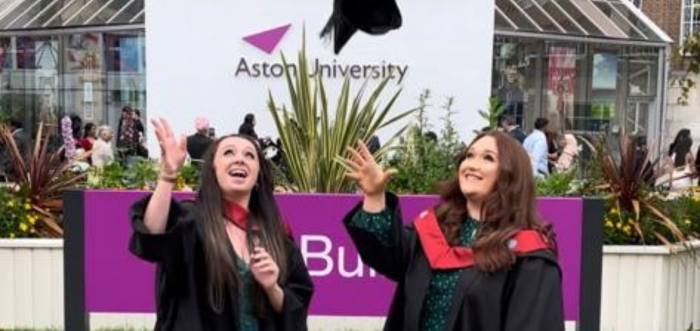 Katie Mills and Jenny Murfin at their graduation ceremony in front of Aston University. 